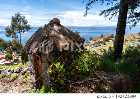 Traditional huts overlooking Lake Titicaca on Taquile Island, Peru Traditional huts overlooking Lake Titicaca on Taquile Island, Peru 142423994