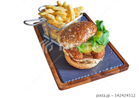 burger with fish and basket of fries on a board burger with fish and basket of fries on a board 142424512