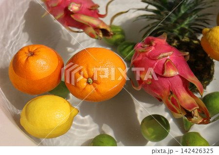 Mix of tropical fruits floating in clean rippling water. Mix of tropical fruits floating in clean rippling water. 142426325