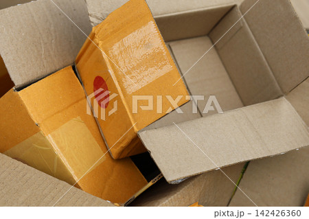 Pile of used open cardboard parcel boxes for recycling Pile of used open cardboard parcel boxes for recycling 142426360