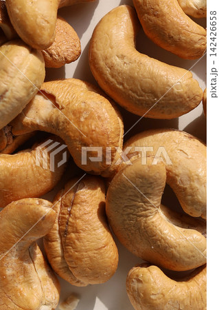 Roasted cashew nuts on a white background. Roasted cashew nuts on a white background. 142426658