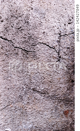 Cracked concrete texture with a rough plaster surface. Cracked concrete texture with a rough plaster surface. 142427849
