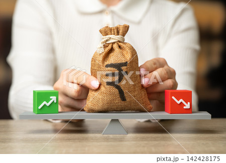 Financial balance and Indian rupee money bag. Income and expenses concept. Cash flow gaps, budgeting and financial management affect business stability. Financial balance and Indian rupee money bag. Income and expenses concept. Cash flow gaps, budgeting and financial management affect business stability. 142428175