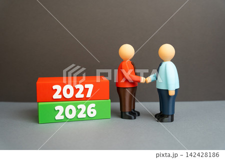 Two businessmen shake hands on the threshold of 2027. Year in review and planning new goals. A partnership agreement marks a new stage of cooperation and growth. 142428186