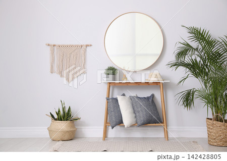 Round mirror and plants at home. Idea for interior design Round mirror and plants at home. Idea for interior design 142428805