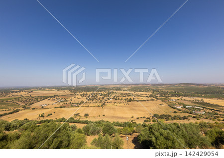 Vast agricultural landscape under clear sky in a rural area with fields and hills in view Vast agricultural landscape under clear sky in a rural area with fields and hills in view 142429054