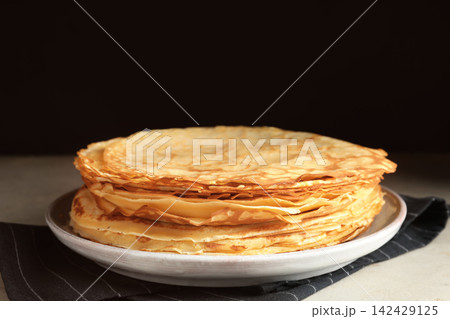 Stack of fresh thin pancakes on table Stack of fresh thin pancakes on table 142429125