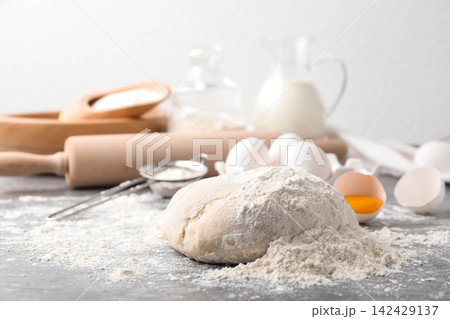 Wheat dough and products on grey table. Cooking pastries 142429137