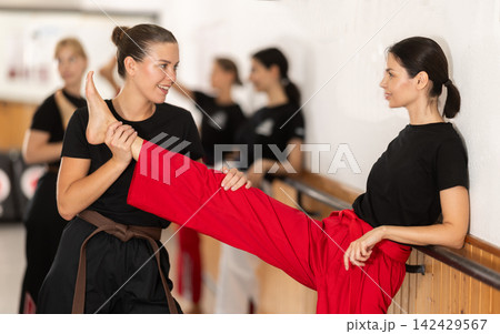 Woman Helps Stretch Another Woman Woman Helps Stretch Another Woman 142429567