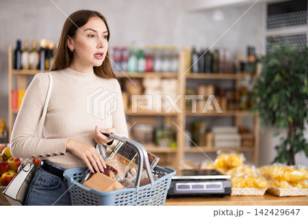 Young woman choosing food in grocery store 142429647