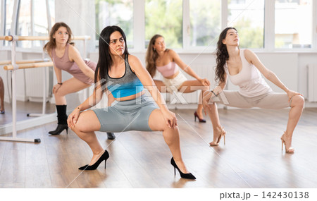 Young female dancer in high heels practicing jazz-funk in studio 142430138