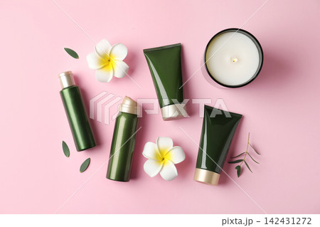Flat lay composition with cosmetic products and tropical flowers on pink background Flat lay composition with cosmetic products and tropical flowers on pink background 142431272