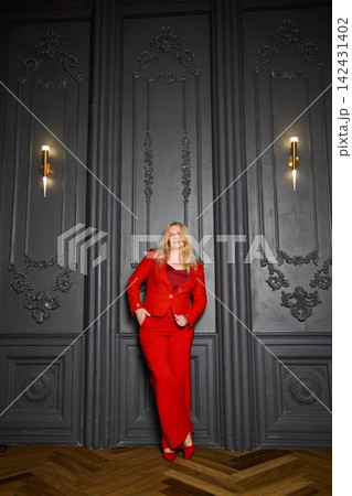 Selfassured woman in tailored attire gets ready to speak on stage Selfassured woman in tailored attire gets ready to speak on stage 142431402