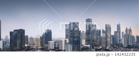 Panoramic view of Jakarta's modern city skyline with skyscrapers at twilight. Jakarta, Indonesia. Cityscapes background Panoramic view of Jakarta's modern city skyline with skyscrapers at twilight. Jakarta, Indonesia. Cityscapes background 142432235