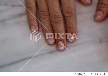 Gleaming Nails on Marble Surface Gleaming Nails on Marble Surface 142434231
