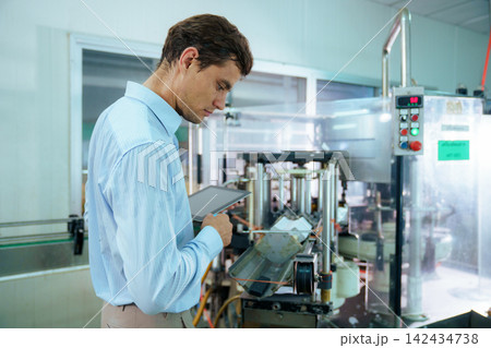Focused male engineer using digital tablet on factory production line Focused male engineer using digital tablet on factory production line 142434738