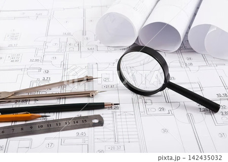 Architectural blueprints with tools and rolled plans Architectural blueprints with tools and rolled plans 142435032