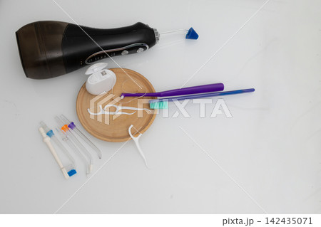 Dental care items on a clean bathroom countertop for at-home oral hygiene Dental care items on a clean bathroom countertop for at-home oral hygiene 142435071