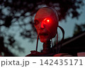 Side profile of an android face with a bright laser-like red eye. Cables and neck tubing add sci-fi detail in a spooky Halloween yard display. 142435171