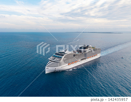 Aerial view luxury liner. Ship leaving Miami beach port. Cruise ship vacation. Aerial view cruise ship on summer vacation tour. Cruise ship vacation and travel by sea. Voyage across sea 142435957