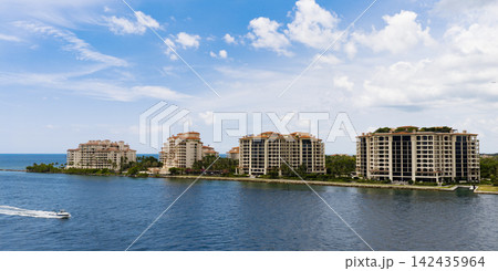 Aerial night view of Miami coastline. Twilight skyline above the Miami oceanfront. Miami Beach waterfront with dramatic sky. 142435964