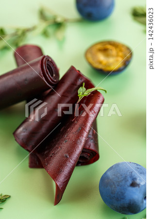 Plum fruit leather with fresh plums and herbs viewed from above Plum fruit leather with fresh plums and herbs viewed from above 142436023
