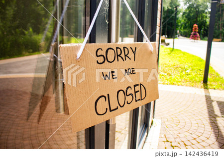 Sign SORRY WE ARE CLOSED on welcome door of small shop. Local business closure. Owners facing economic struggles and client loss Sign SORRY WE ARE CLOSED on welcome door of small shop. Local business closure. Owners facing economic struggles and client loss 142436419