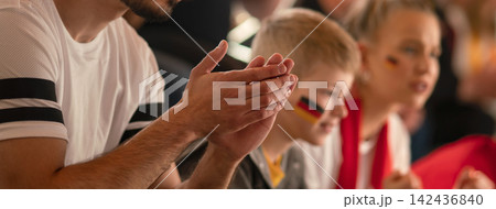 Football fans supproting German national team in live soccer match at stadium. Football fans supproting German national team in live soccer match at stadium. 142436840