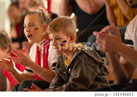 Worried football fans supproting German national team in live soccer match at stadium. Worried football fans supproting German national team in live soccer match at stadium. 142436855