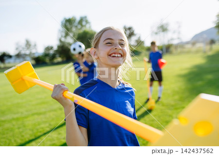 Children helping prepare football training session on sports field. Children helping prepare football training session on sports field. 142437562
