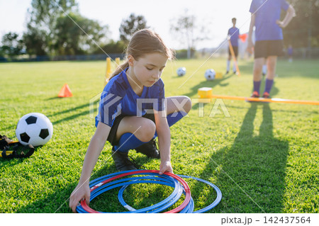 Children helping prepare football training session on sports field. Children helping prepare football training session on sports field. 142437564