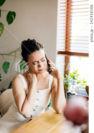 Confident woman sitting on sofa and making phone call. 142438166