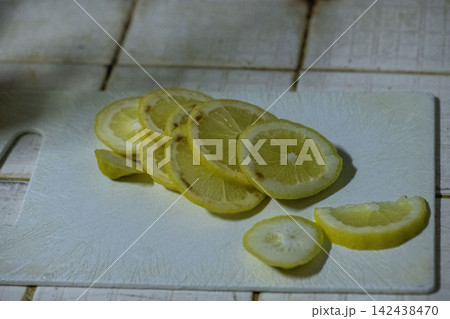 Lemon slice on cutting board with fresh citrus pieces Lemon slice on cutting board with fresh citrus pieces 142438470