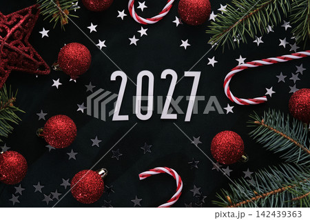 New Year 2027 dark background. Number of the coming year in Christmas decoration. New Year 2027 dark background. Number of the coming year in Christmas decoration. 142439363
