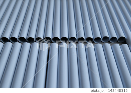 Rows of white metal pipes or tubes in a box Rows of white metal pipes or tubes in a box 142440513