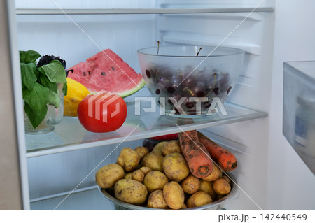 Open Refrigerator with Fresh Fruits and Vegetables Open Refrigerator with Fresh Fruits and Vegetables 142440549