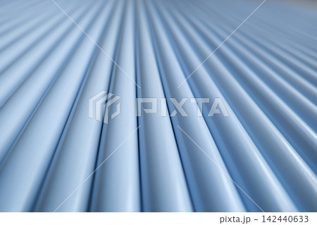 Steel pipes stacked in industrial warehouse close up Steel pipes stacked in industrial warehouse close up 142440633