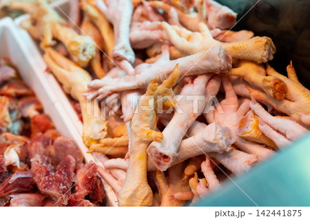 Tray is filled with chicken paws, chilled meat products. Tray is filled with chicken paws, chilled meat products. 142441875