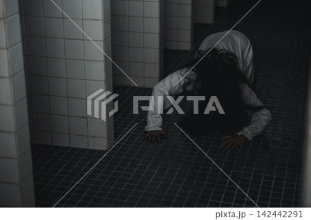 Halloween horror scene featuring woman, scary ghost costume crawling on dark tiled floor inside abandoned creepy spooky building, eerie mood for festival celebration concept 142442291