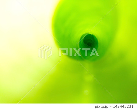 Abstract macro shot looking down center of curled green banana leaf showing spiral pattern. Abstract macro shot looking down center of curled green banana leaf showing spiral pattern. 142443231