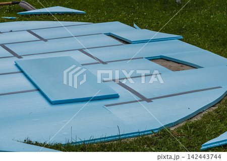 Preparing pool base with foam boards for backyard installation project Preparing pool base with foam boards for backyard installation project 142443744