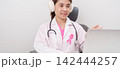 Professional doctor using laptop for telehealth, telemedical, online consultation and video meeting about Breast Cancer Awareness month, World Cancer Day and Pink October in hospital office concept 142444257