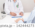 Doctor and patient having a medical consultation for green and pink ribbon to patient for concept of October Metastatic Breast Cancer Awareness month, National Cancer Survivors Month and Pink October 142444273