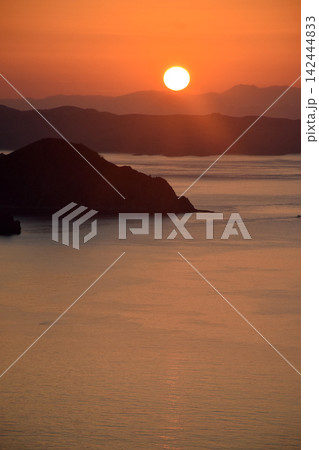 The beautiful sunrise on Padar Island in West Manggarai, Flores, Indonesia, with its reddish-yellow rays. 142444833