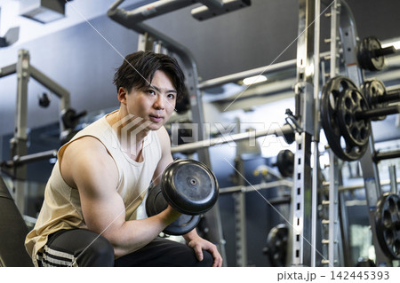 スポーツジムでトレーニングする若い男性 142445393
