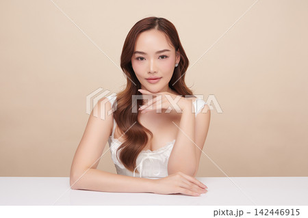 A beautiful young Asian woman with clean, fresh skin against a beige background. Skincare, facial treatment, cosmetology, beauty, and spa. An elegant portrait of an Asian woman. A beautiful young Asian woman with clean, fresh skin against a beige background. Skincare, facial treatment, cosmetology, beauty, and spa. An elegant portrait of an Asian woman. 142446915