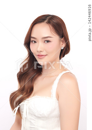 A beautiful young Asian woman with clean, fresh skin against a white background. Skincare, facial treatment, cosmetology, beauty, and spa. An elegant portrait of an Asian woman. A beautiful young Asian woman with clean, fresh skin against a white background. Skincare, facial treatment, cosmetology, beauty, and spa. An elegant portrait of an Asian woman. 142446916