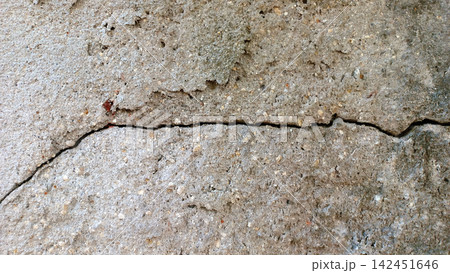 Cracked concrete wall texture with a rough cement surface. Cracked concrete wall texture with a rough cement surface. 142451646