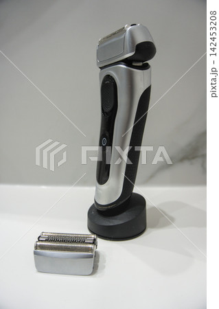 Electric foil shaver with the trimmer folded out and a replacement cassette Electric foil shaver with the trimmer folded out and a replacement cassette 142453208