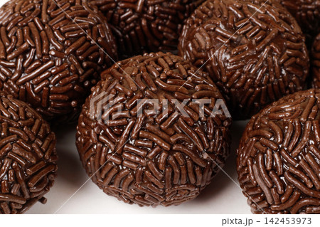 A serving of traditional Brazilian chocolate brigadeiros coated in sprinkles. A popular treat at parties and celebrations. A serving of traditional Brazilian chocolate brigadeiros coated in sprinkles. A popular treat at parties and celebrations. 142453973